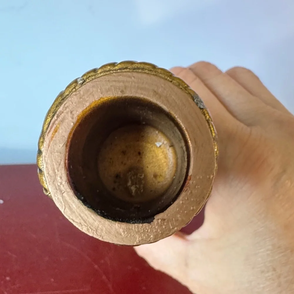 vintage chalkware candle holder featuring a metallic gold-finished figure